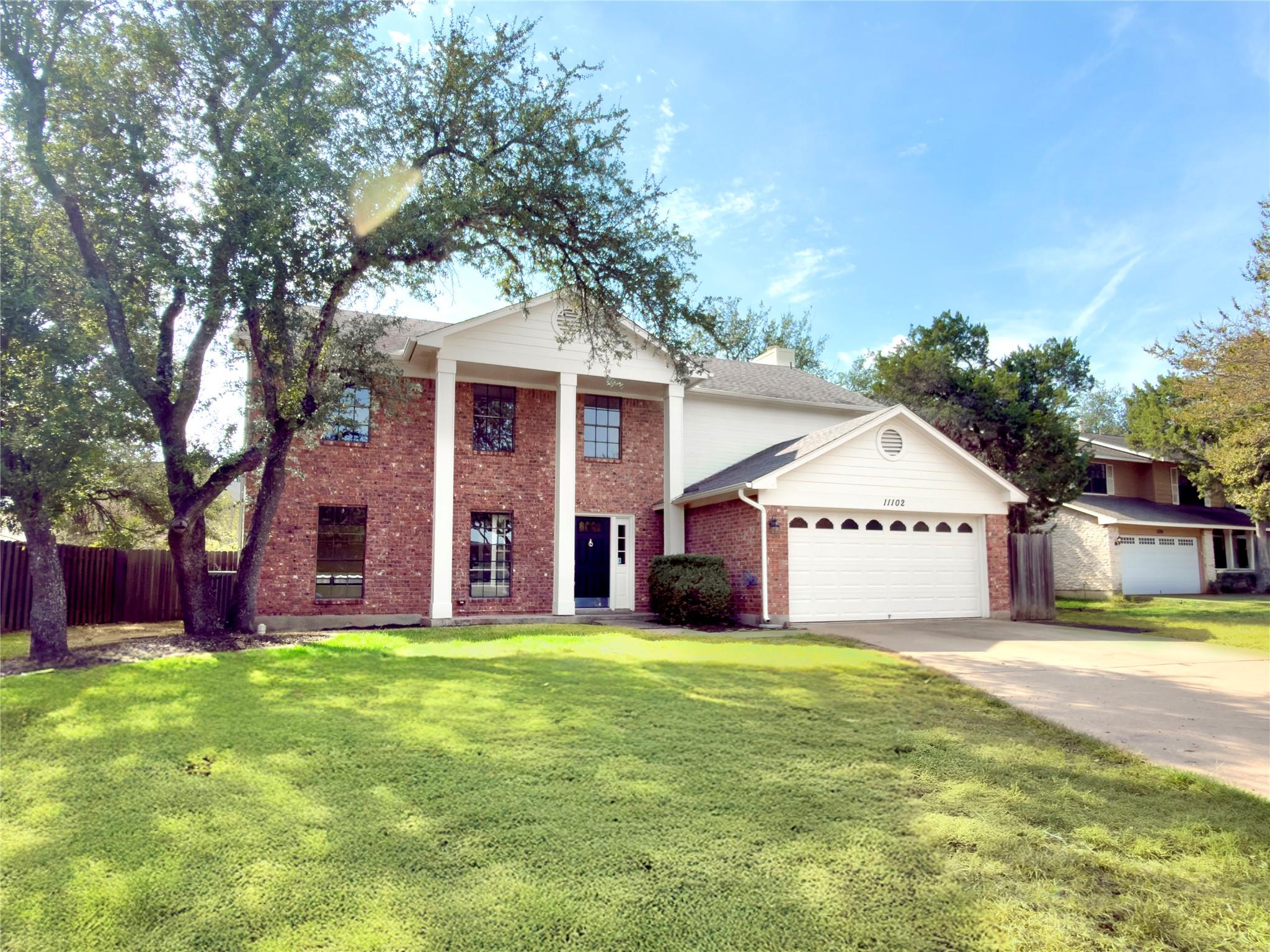 Stately brick columns frame the entrance of this 