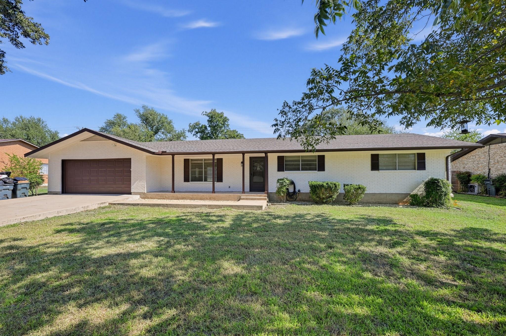 Classic brick accents and a deep front porch high