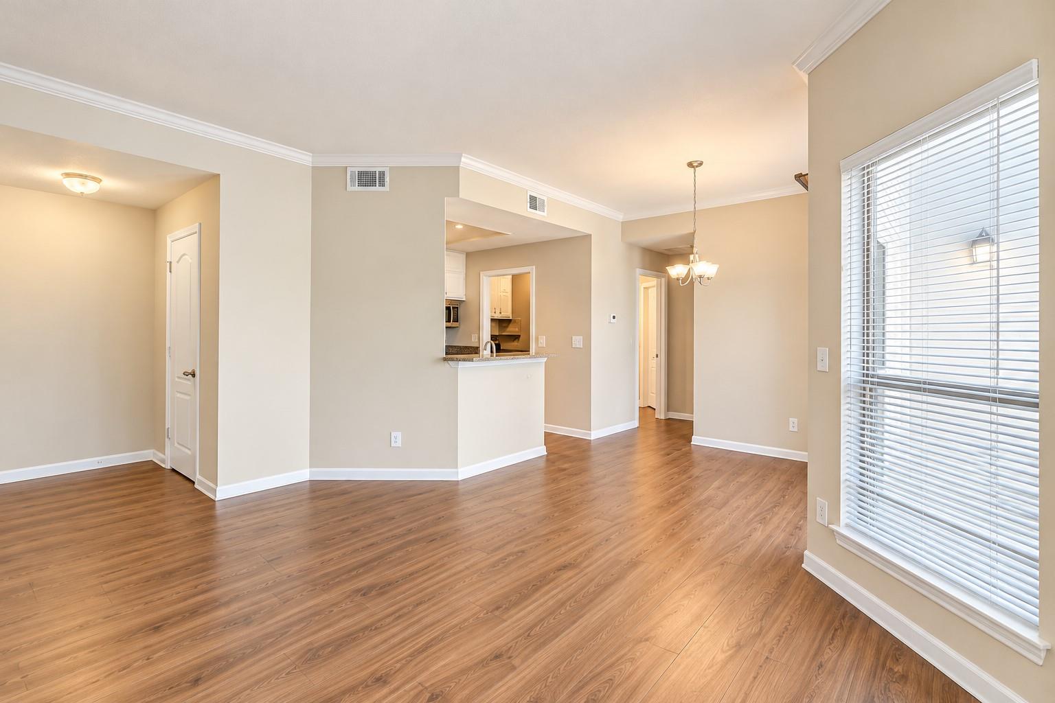 Polished wood floors and clean crown molding flow