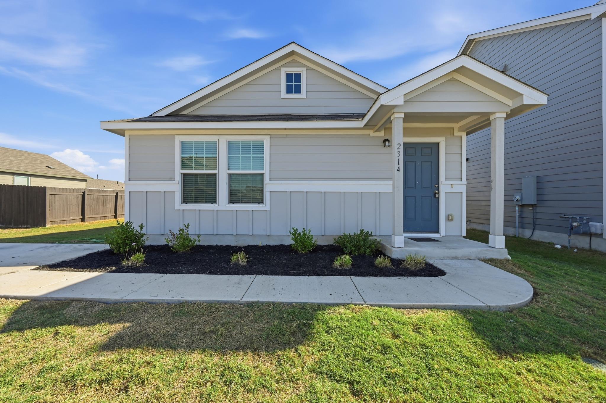 A welcoming front porch with classic columns acce