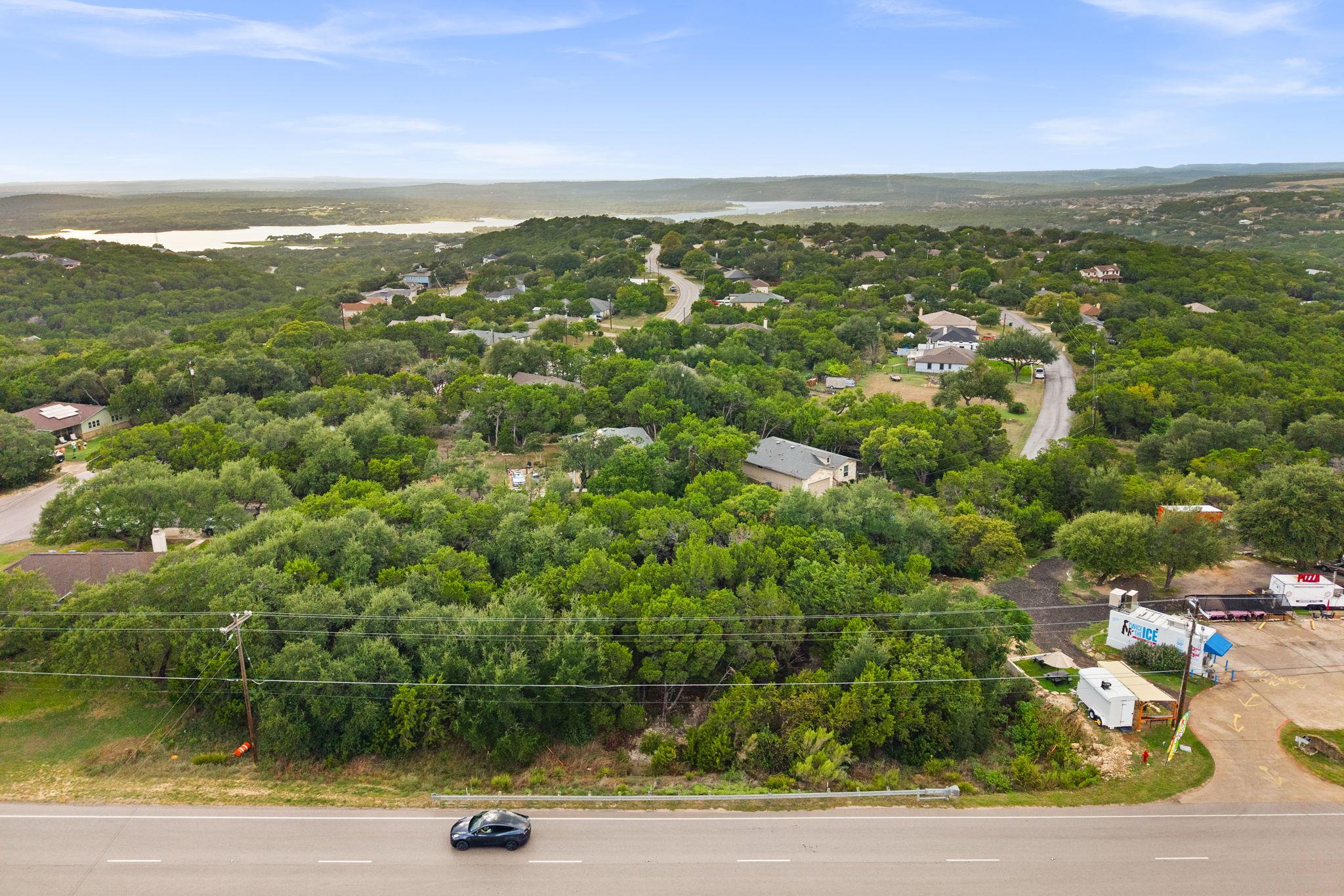 Lush green hillsides and distant water vistas cre