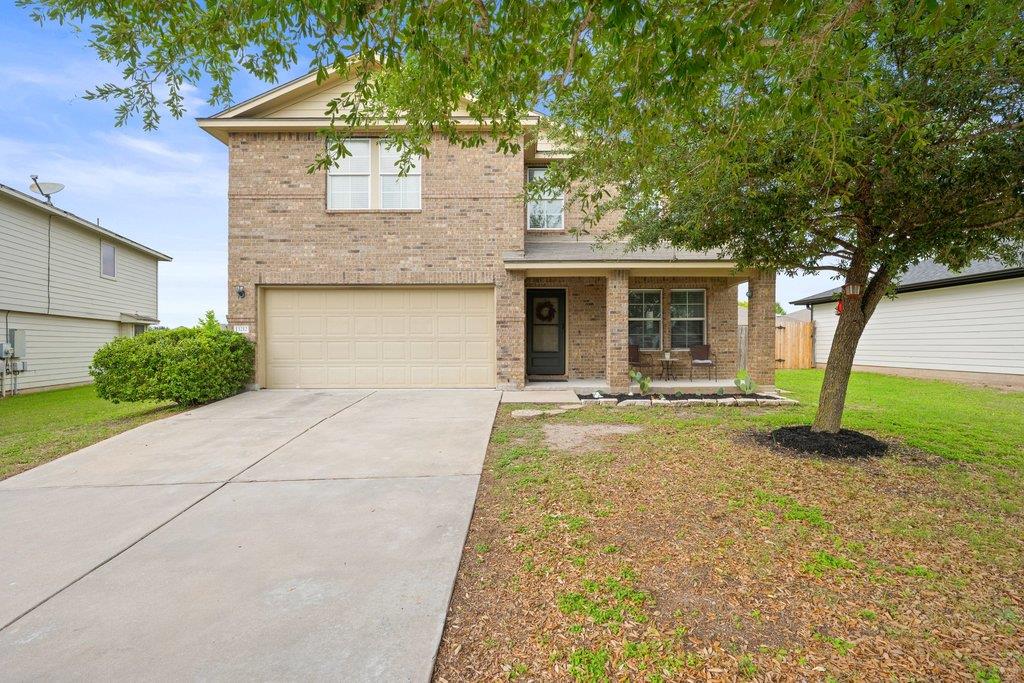 A classic brick exterior features a spacious driv