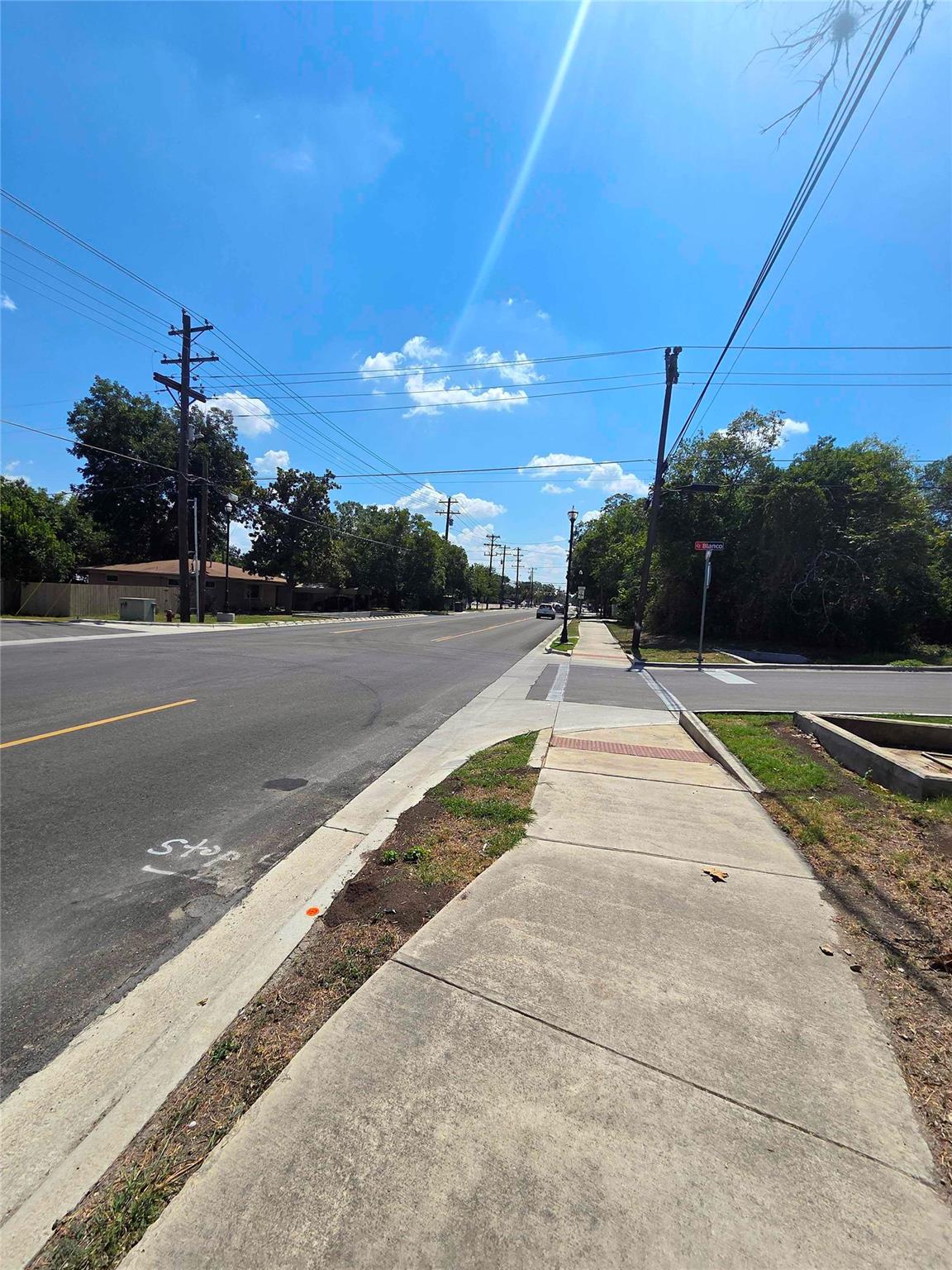 Concrete sidewalks line the paved streets under a