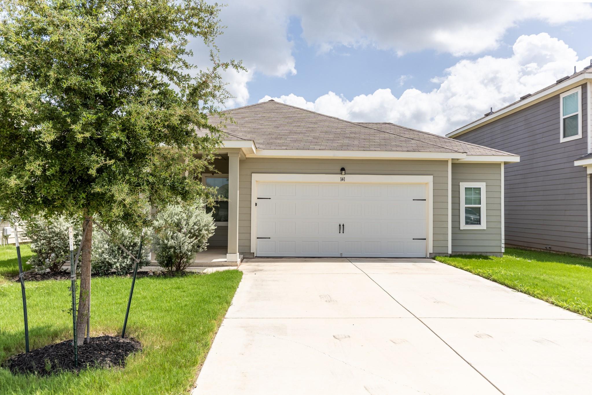 A classic facade features neat lap siding and a s