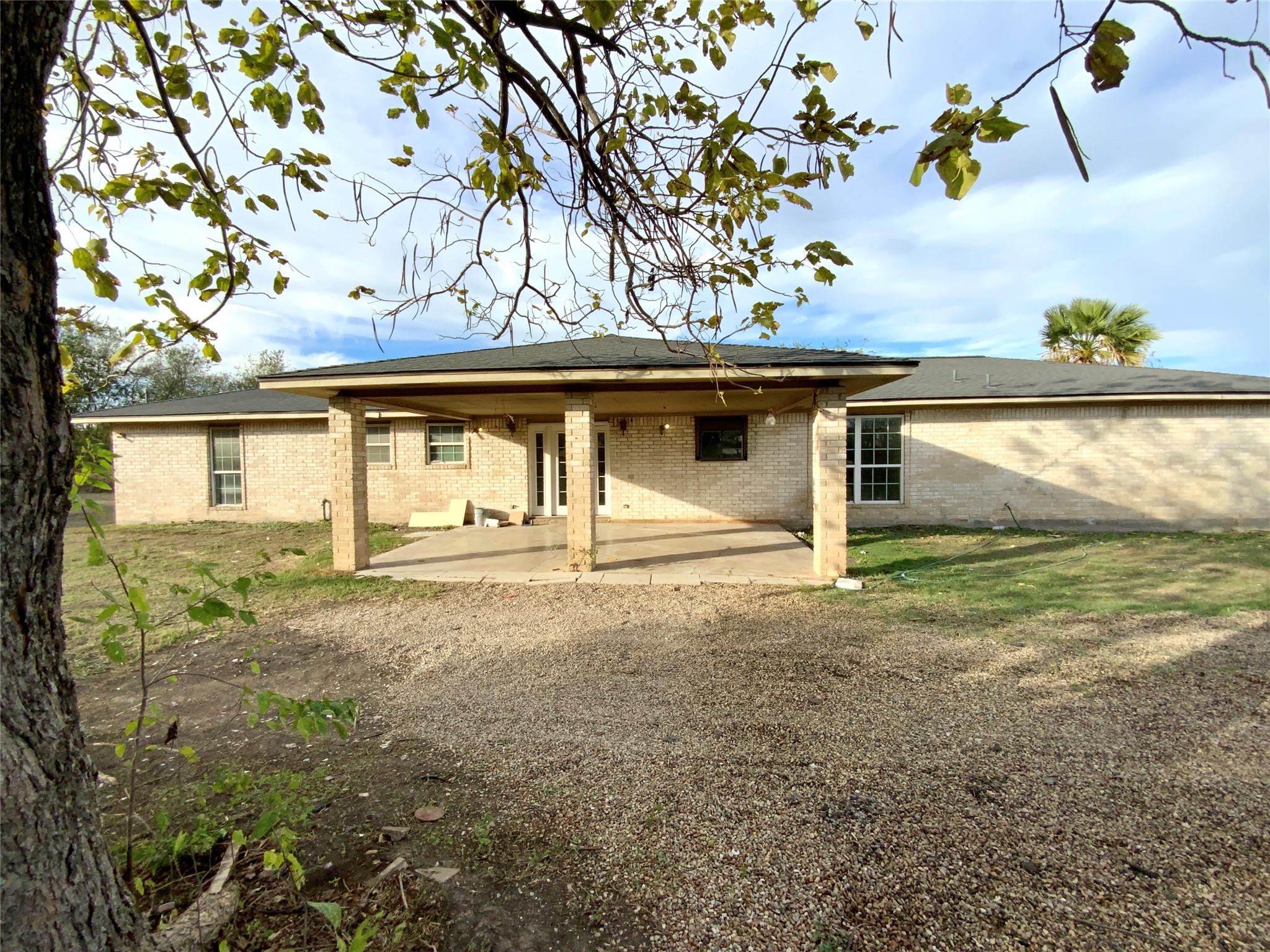 A spacious covered patio anchors the rear facade 