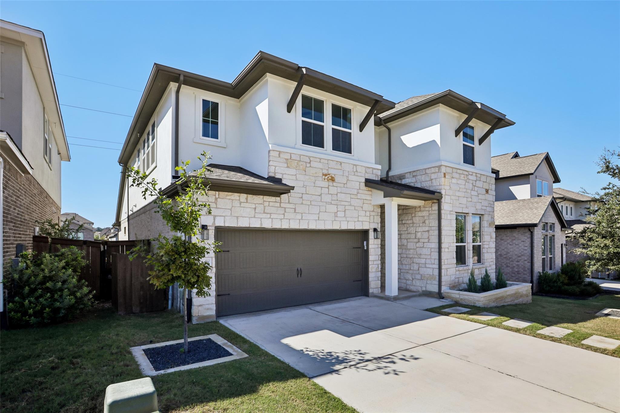 Striking stone and stucco exterior detailing pair
