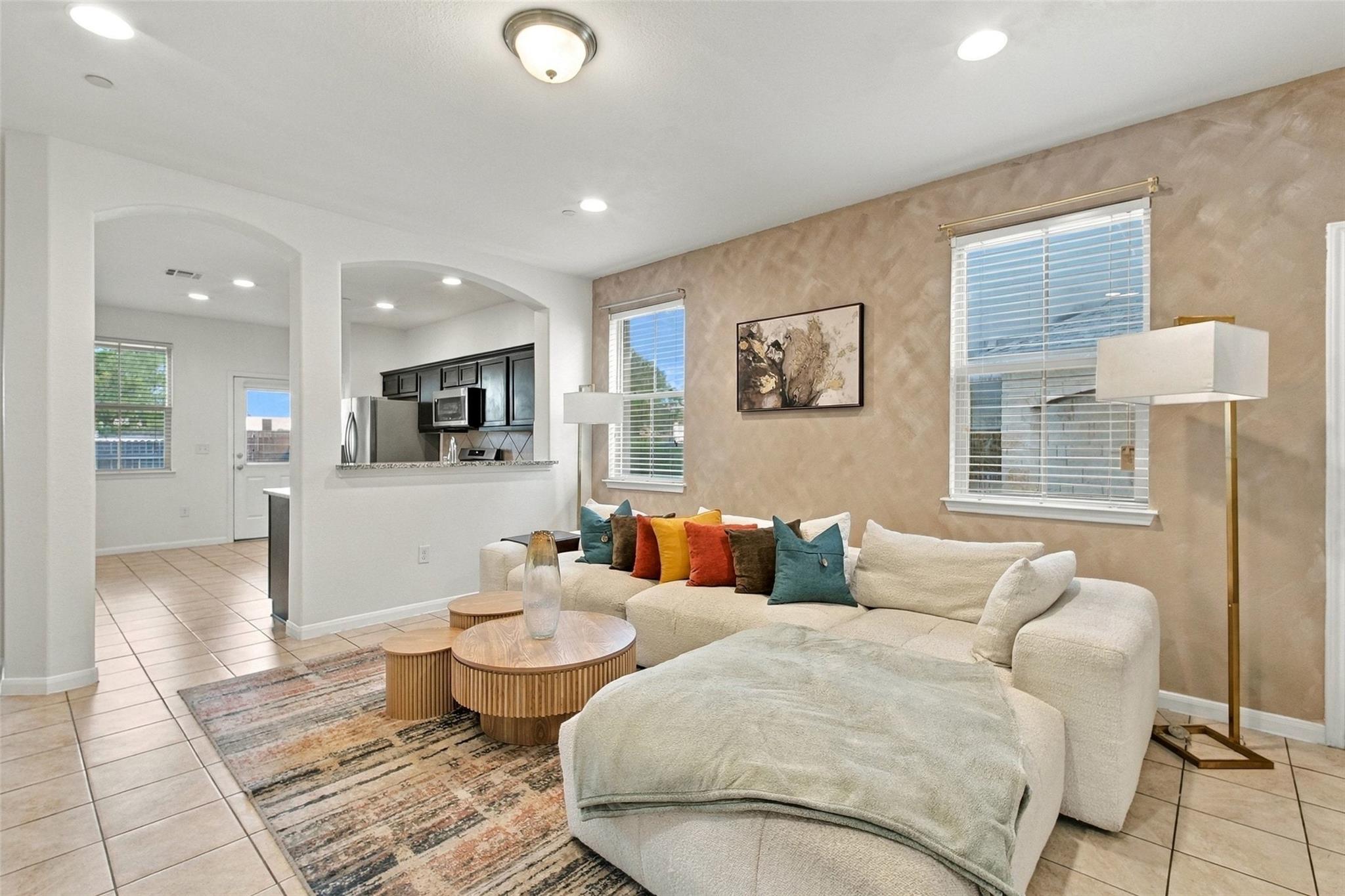 Tiled flooring and arched wall openings connect t