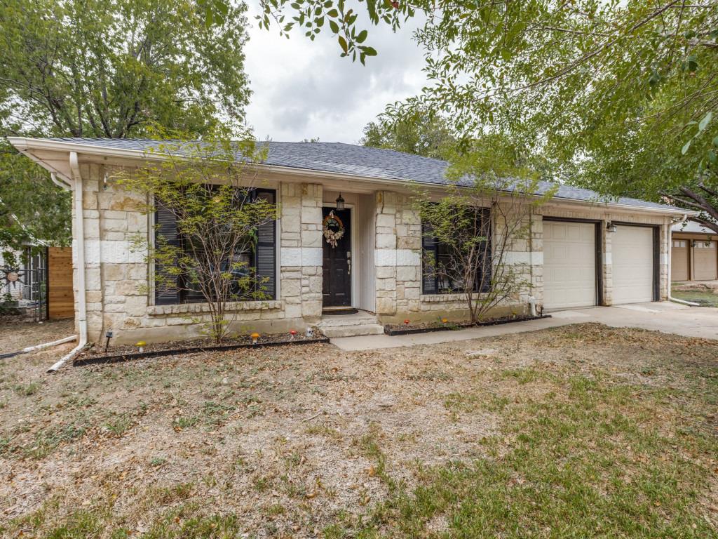 A classic stone exterior integrates with a two-ca