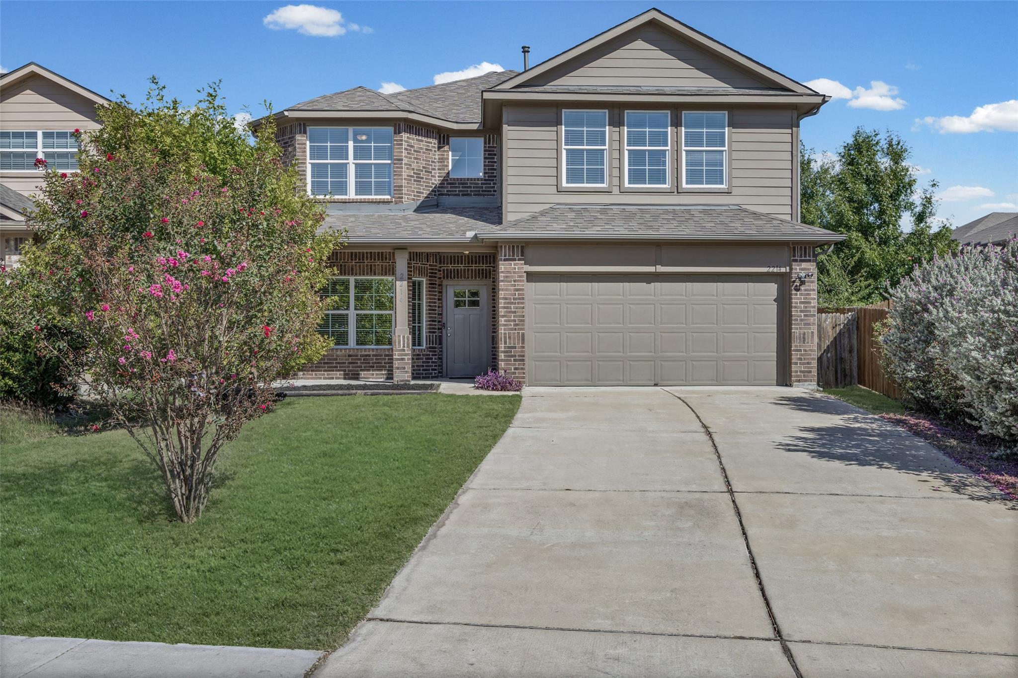 Brick and siding accents define the exterior of t