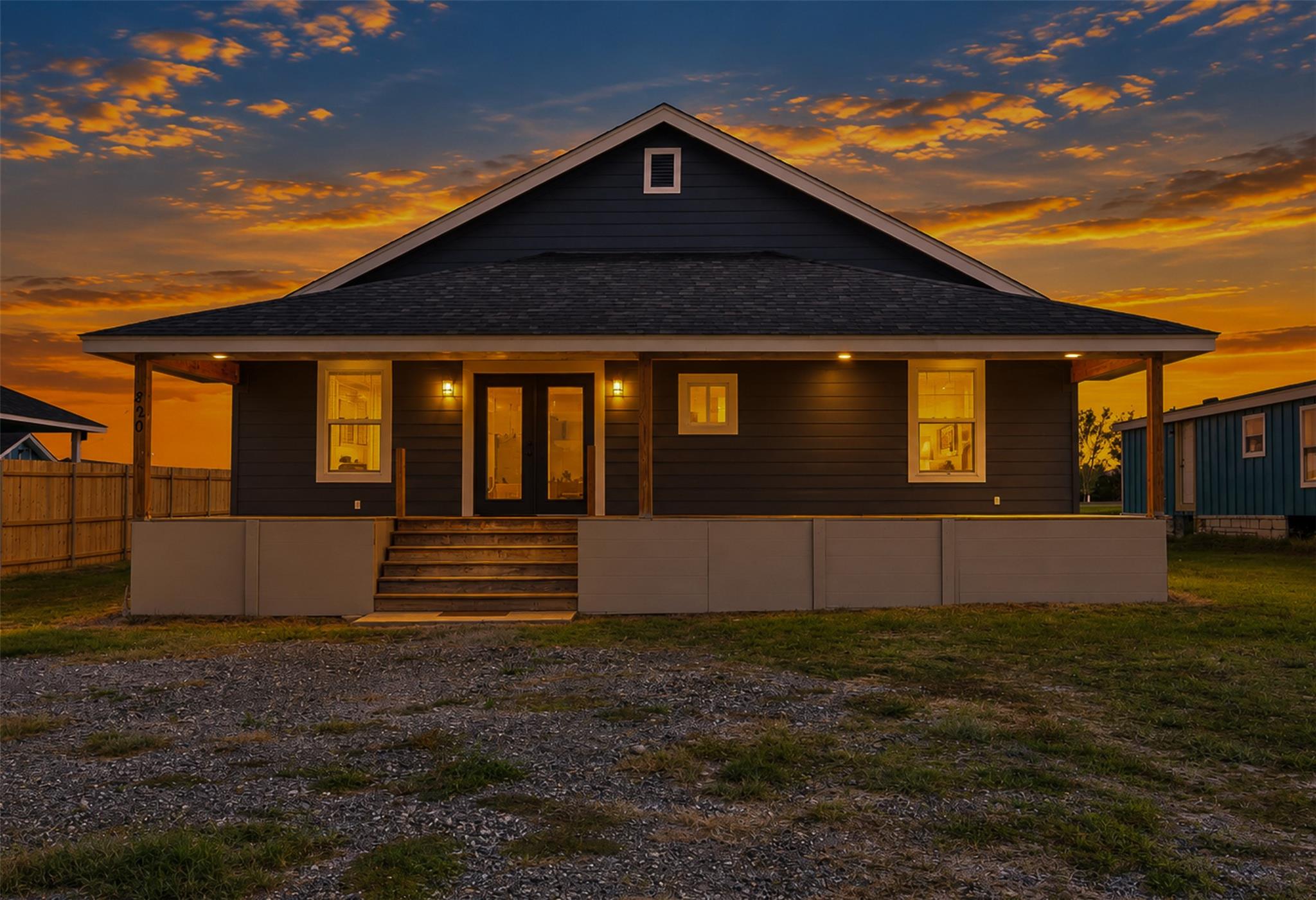 An inviting covered front porch welcomes guests t