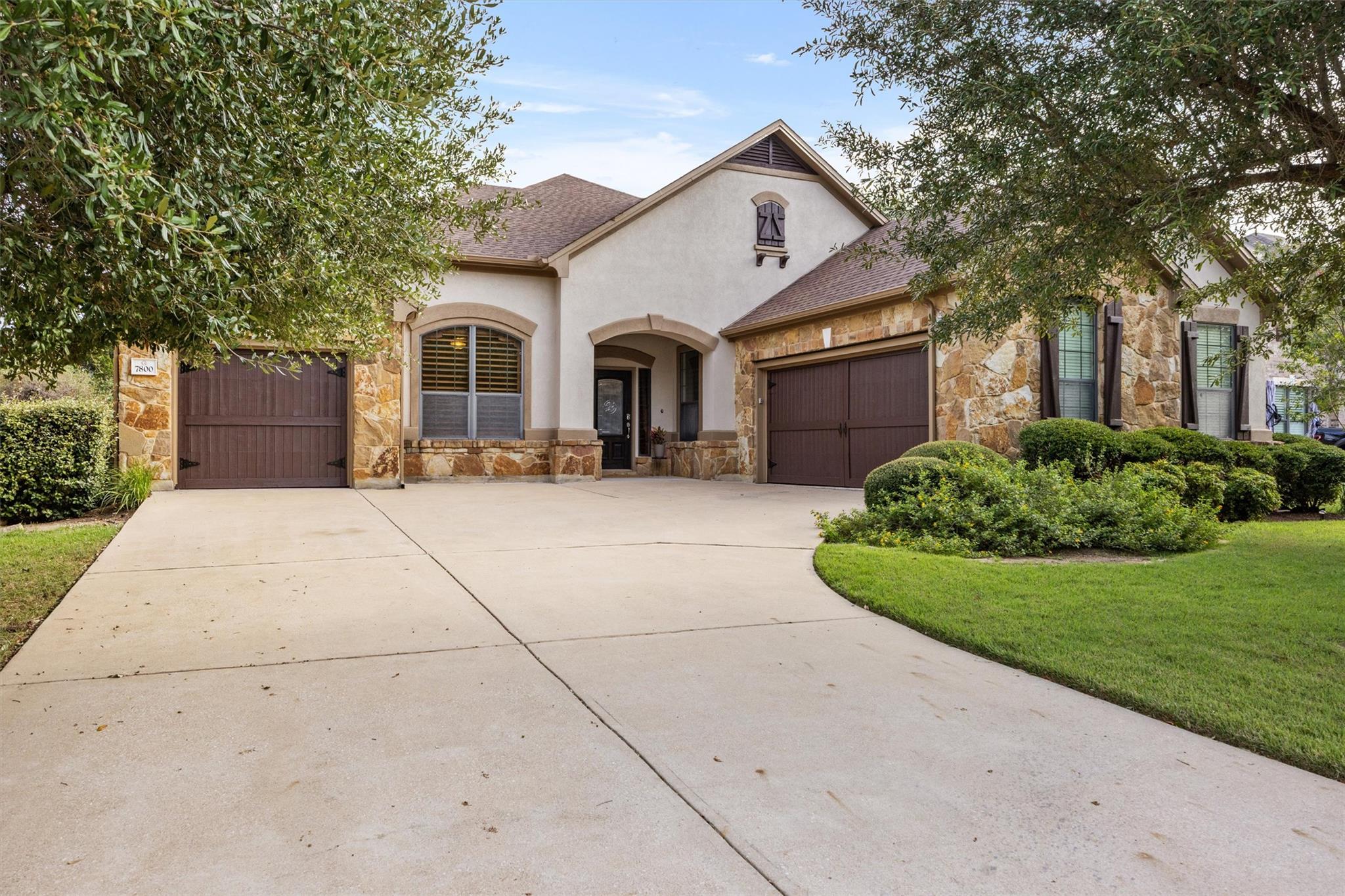 A classic stone and stucco exterior sits behind a