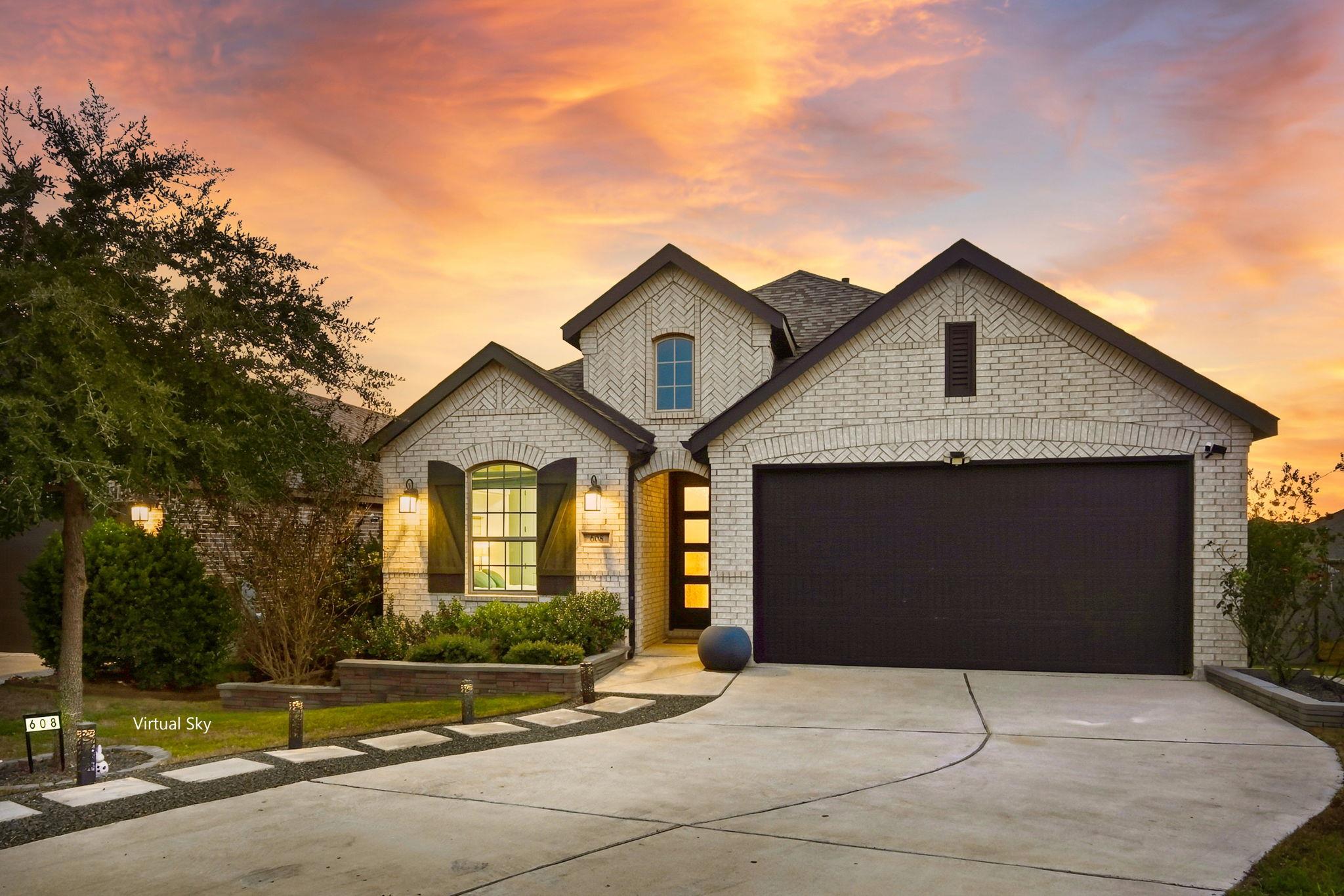 Crisp white brickwork and a spacious driveway def