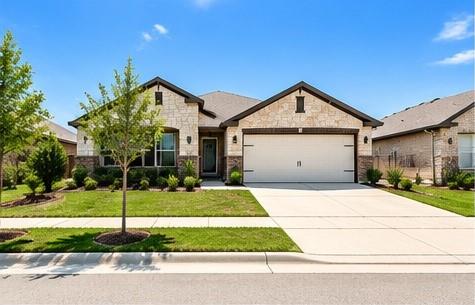 A classic stone facade with a spacious driveway m