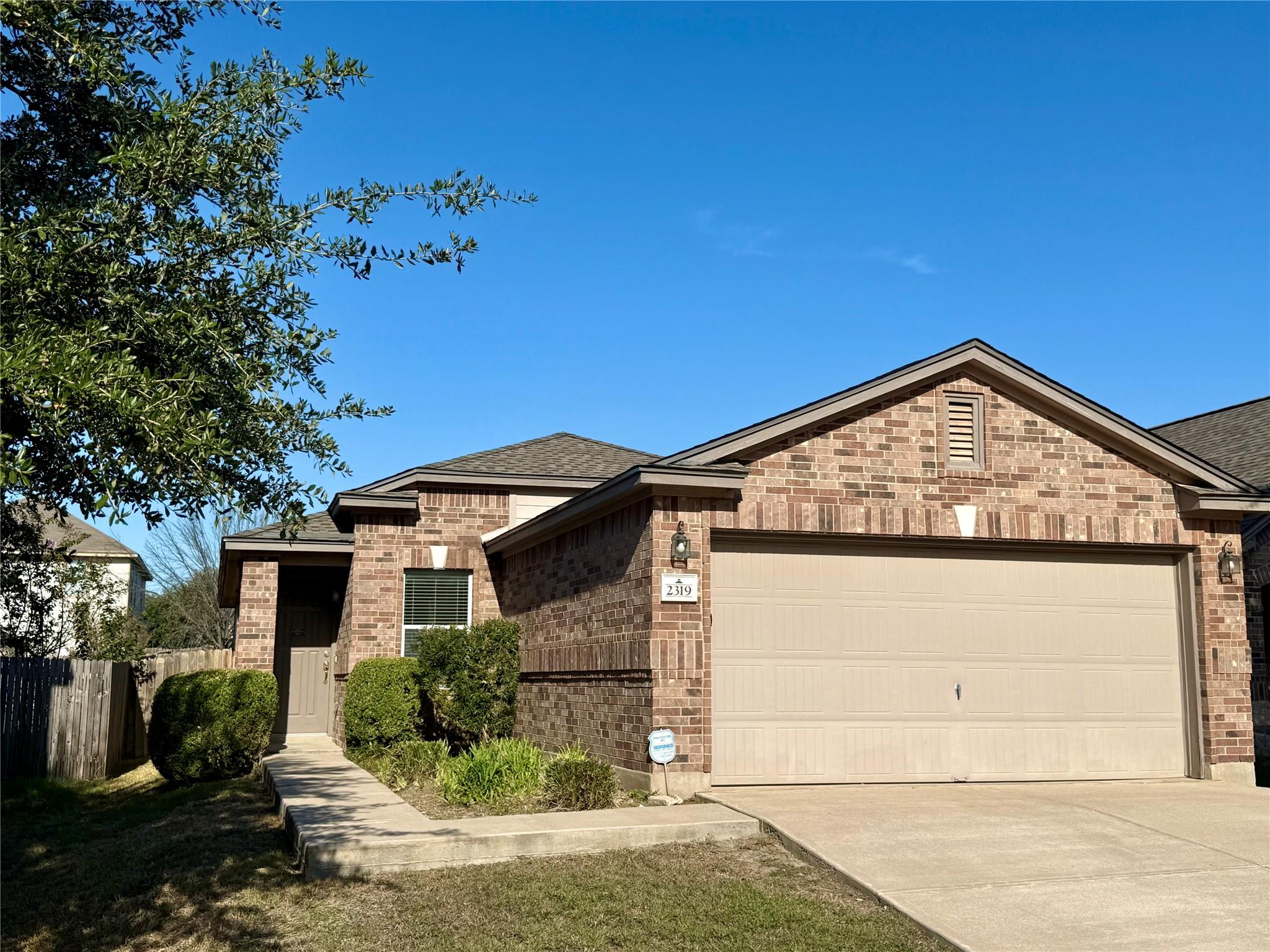 Classic brick exterior showcases an attached two-