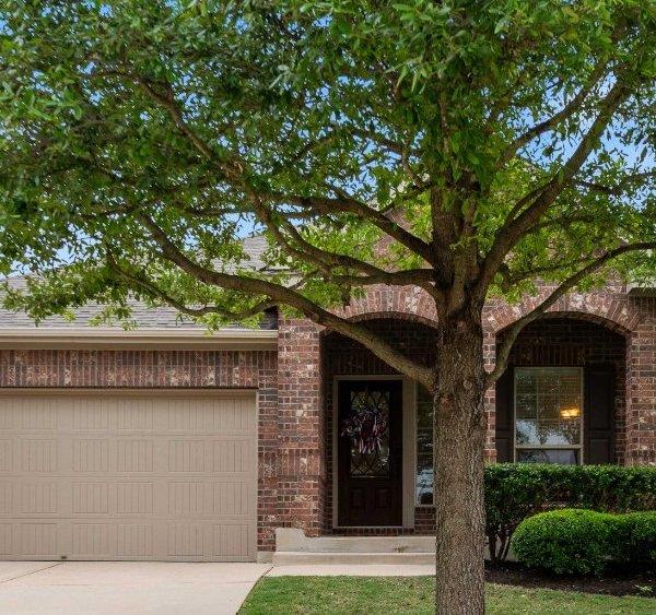 Stately brick construction frames the welcoming f