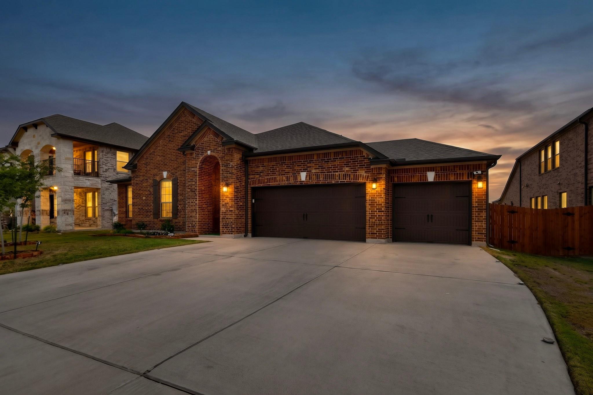 A spacious concrete driveway leads directly to th
