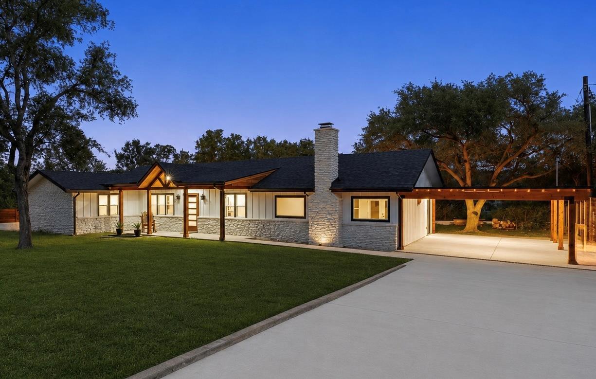 A spacious driveway and neat lawn frame this clas