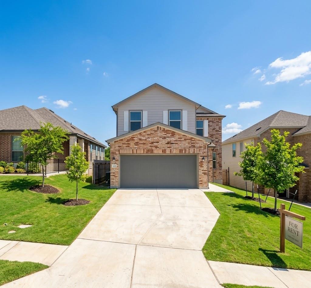 A concrete driveway leads to the two-story brick 
