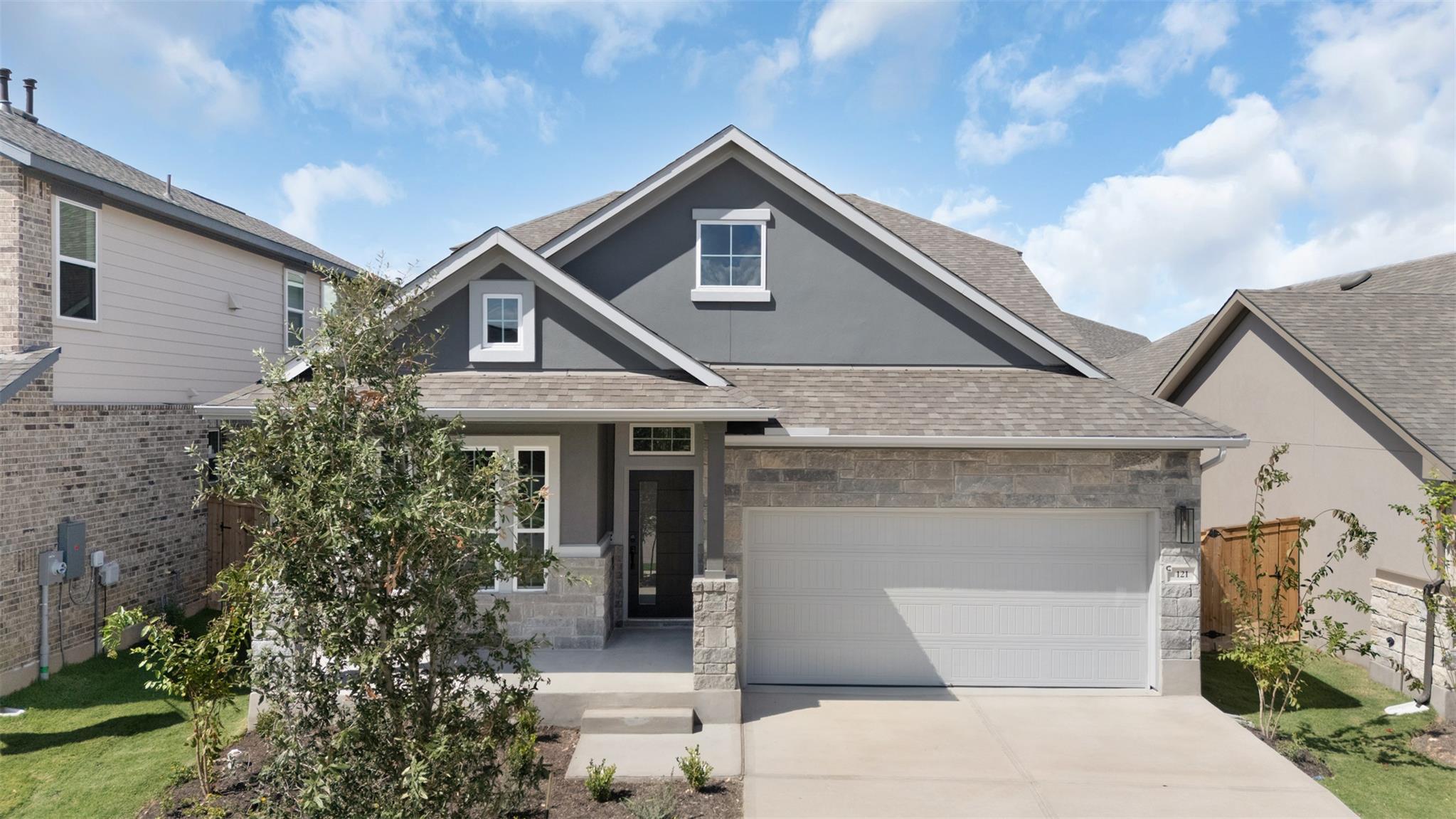 Gabled rooflines and a concrete driveway define t