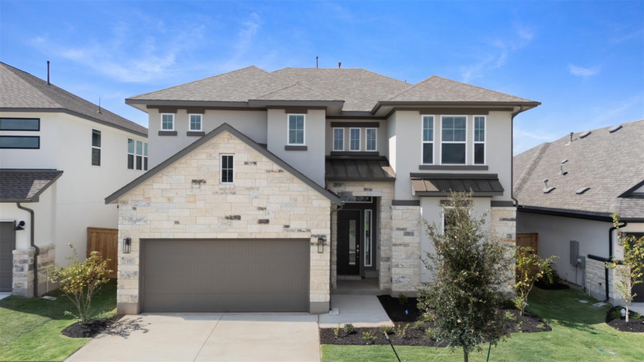 An elegant stone and stucco exterior defines this