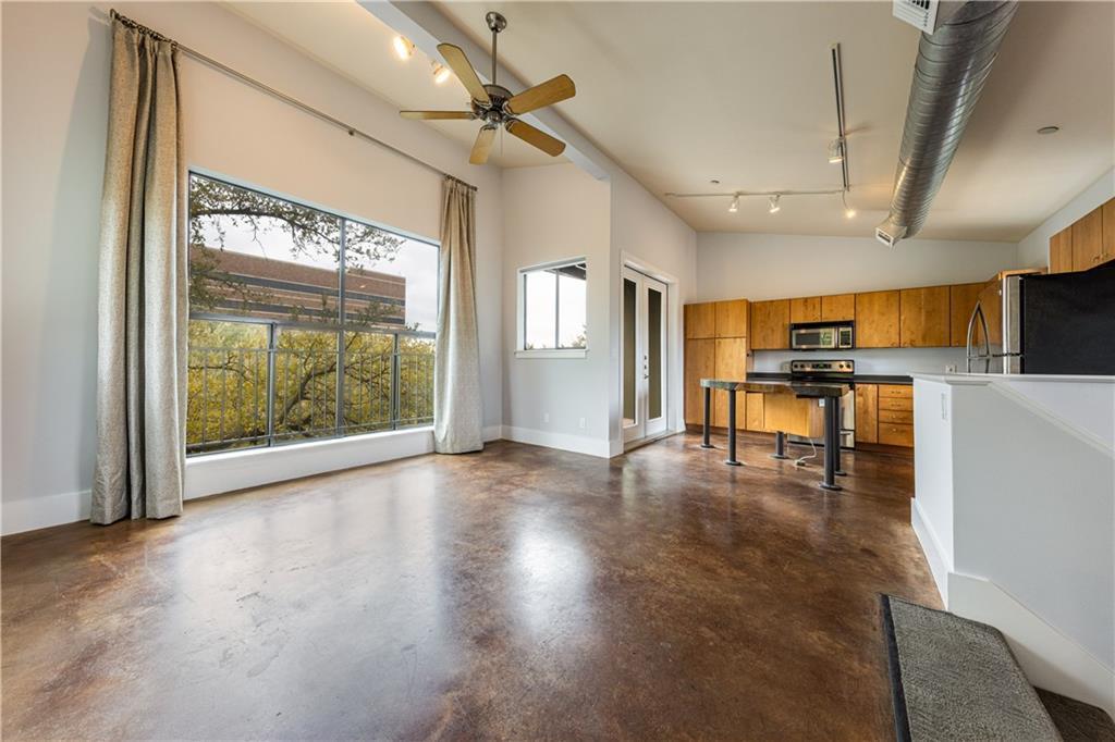 Stained concrete floors and soaring ceilings defi