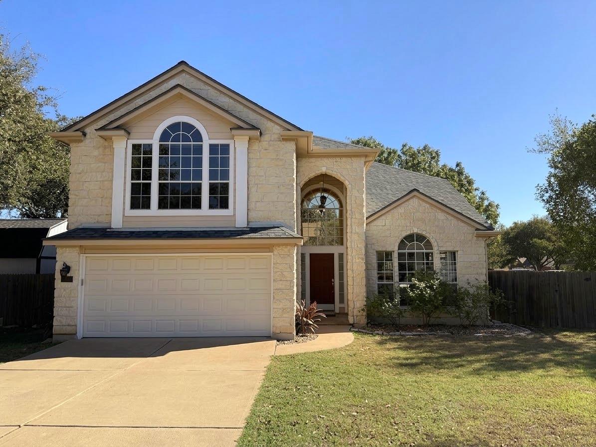 An arched entryway and multi-pane windows define 