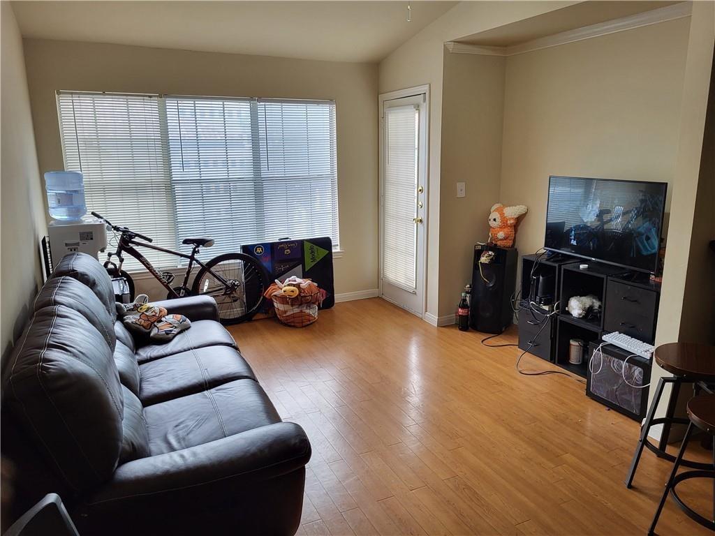 Warm wood flooring and detailed crown molding enh