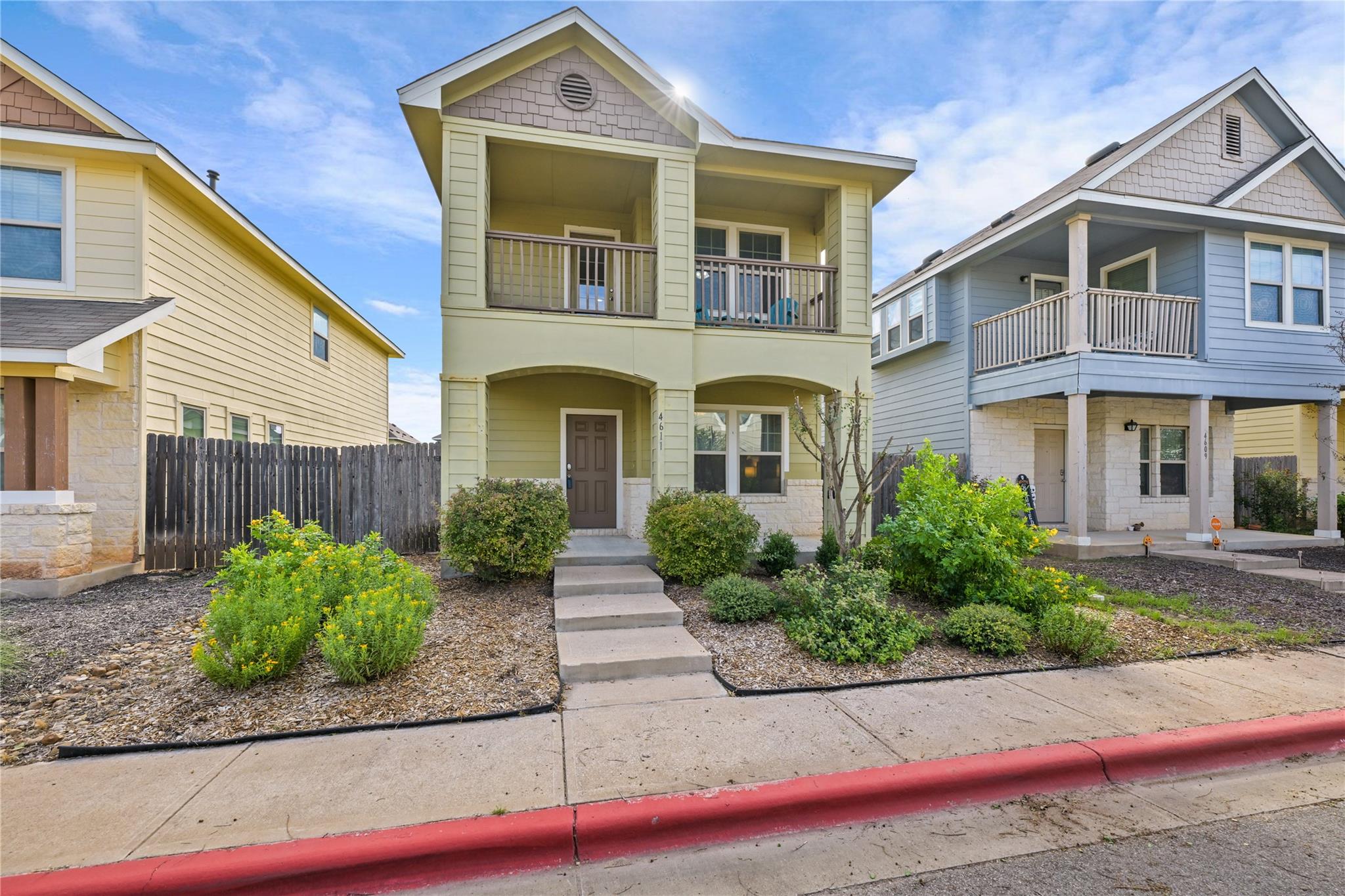 A charming two-story home displays manicured fron