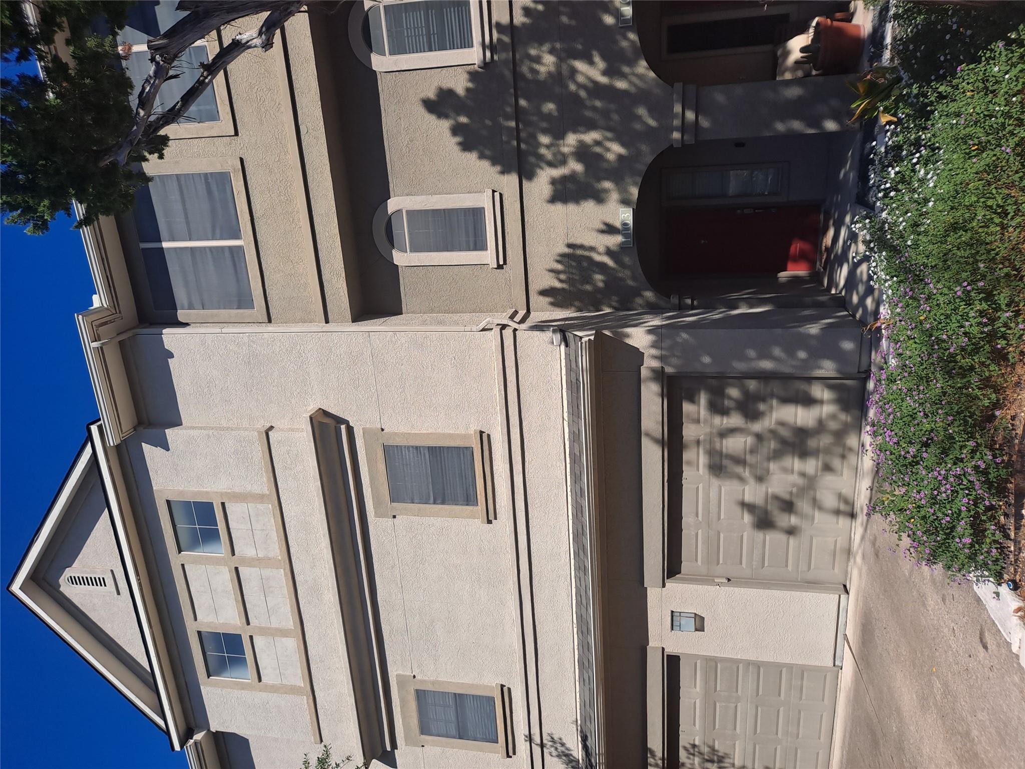 A multi-story exterior showcases a stucco facade 