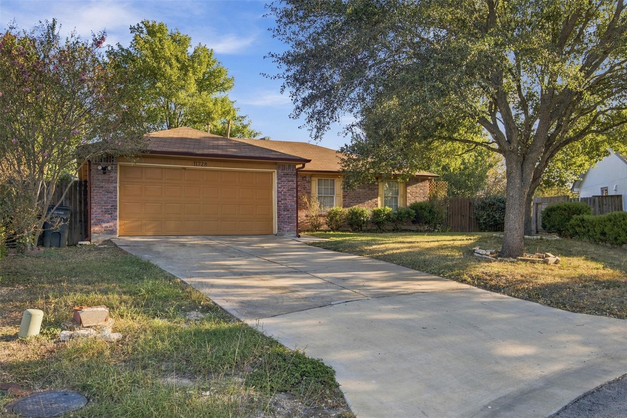 Mature trees shade a classic brick exterior with 