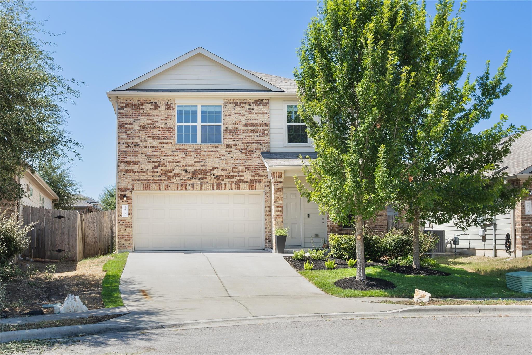 Classic brick exterior and a neat driveway define