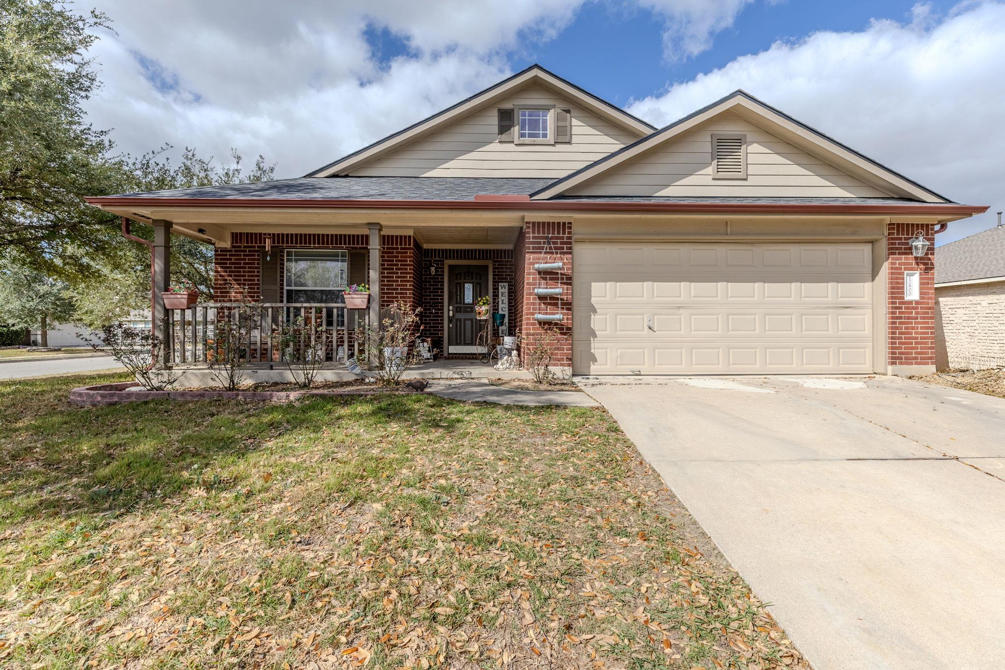 Brick and siding accents define the exterior of t
