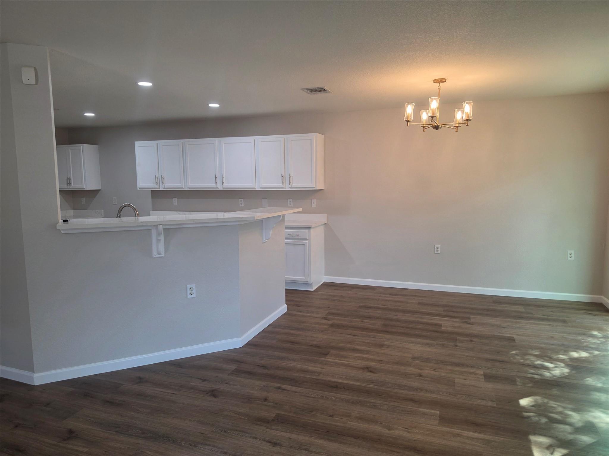 An open floor plan connects the dining area to a 
