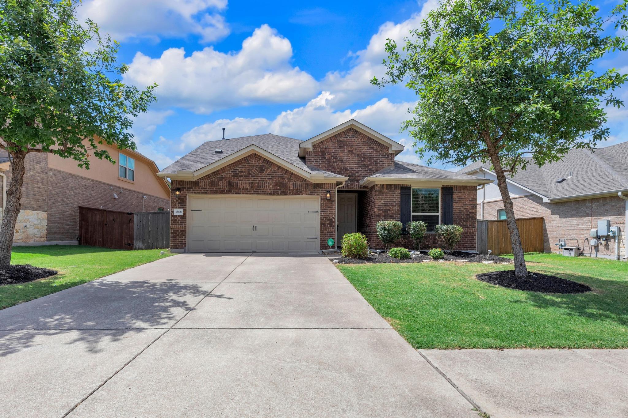 Classic brick exterior and a concrete driveway de