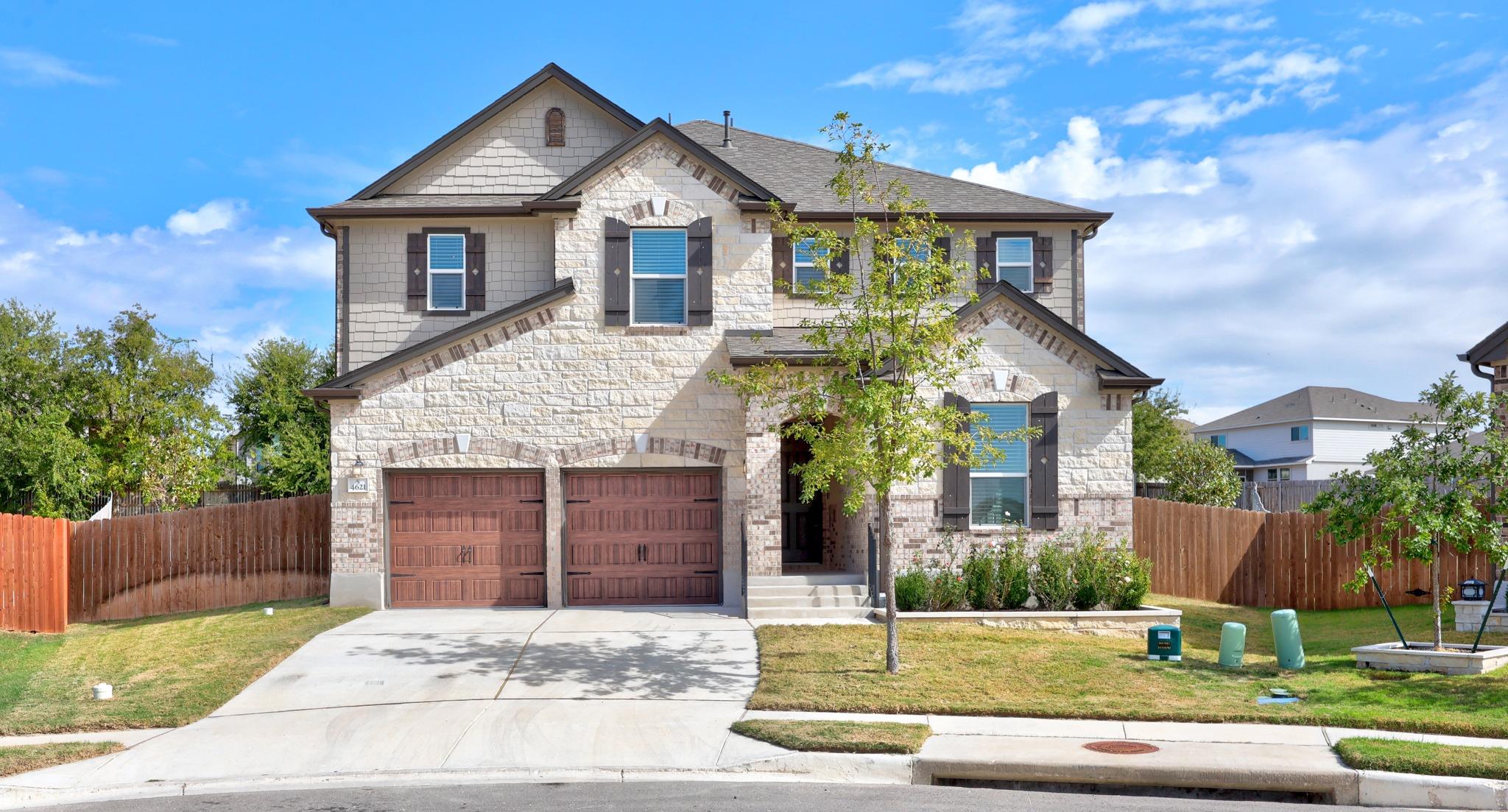A classic stone exterior and wooden garage doors 