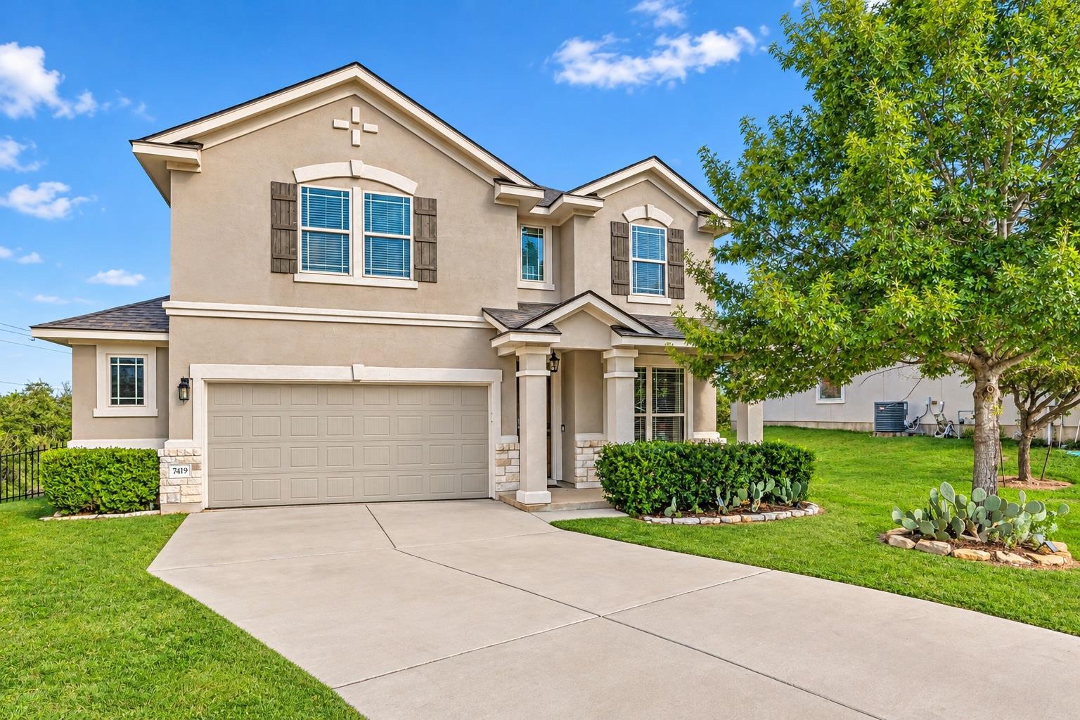 A classic two-story stucco exterior stands behind
