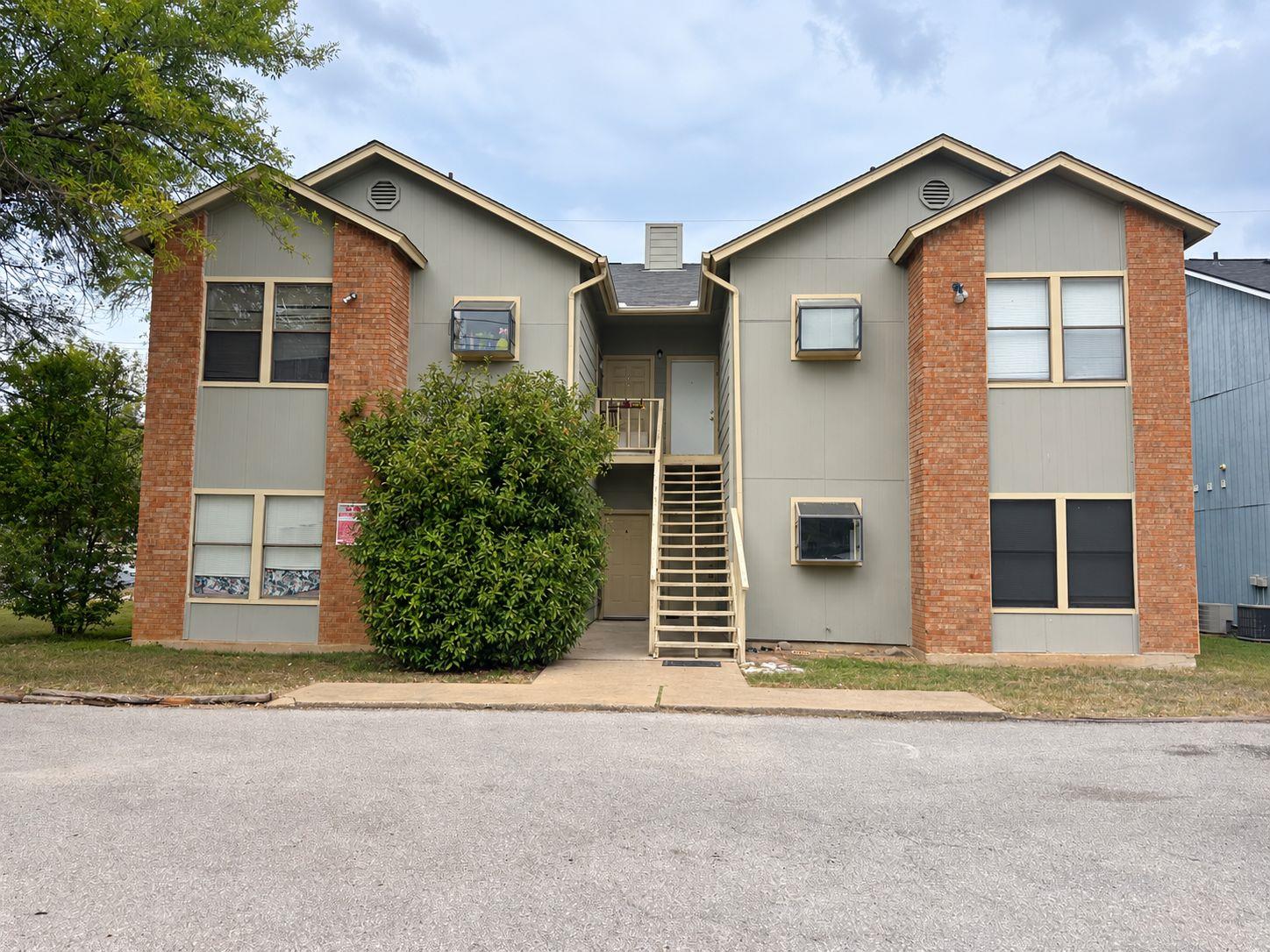 Symmetrical brick and siding architecture defines
