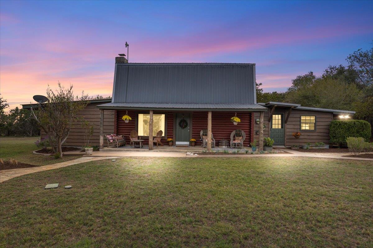 Rustic wood siding and a metal roof define this w