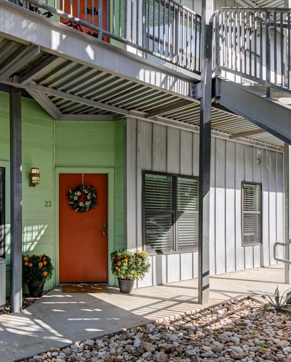 Modern industrial siding and a vibrant entry door
