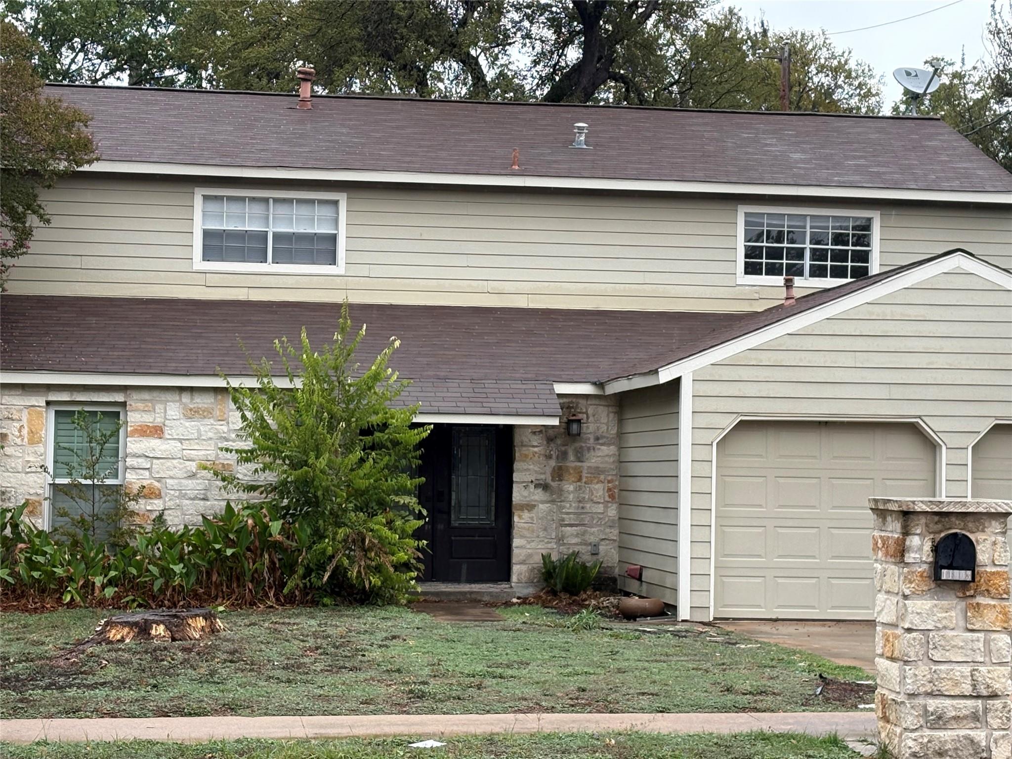 An inviting exterior displays timeless stone acce