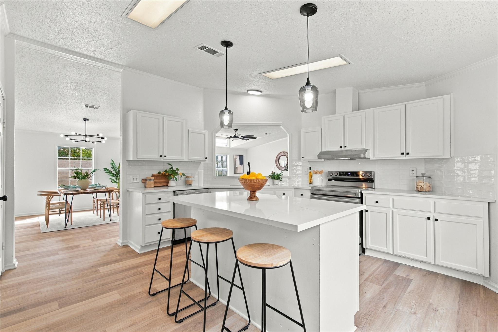 An open kitchen seamlessly connects to adjacent d