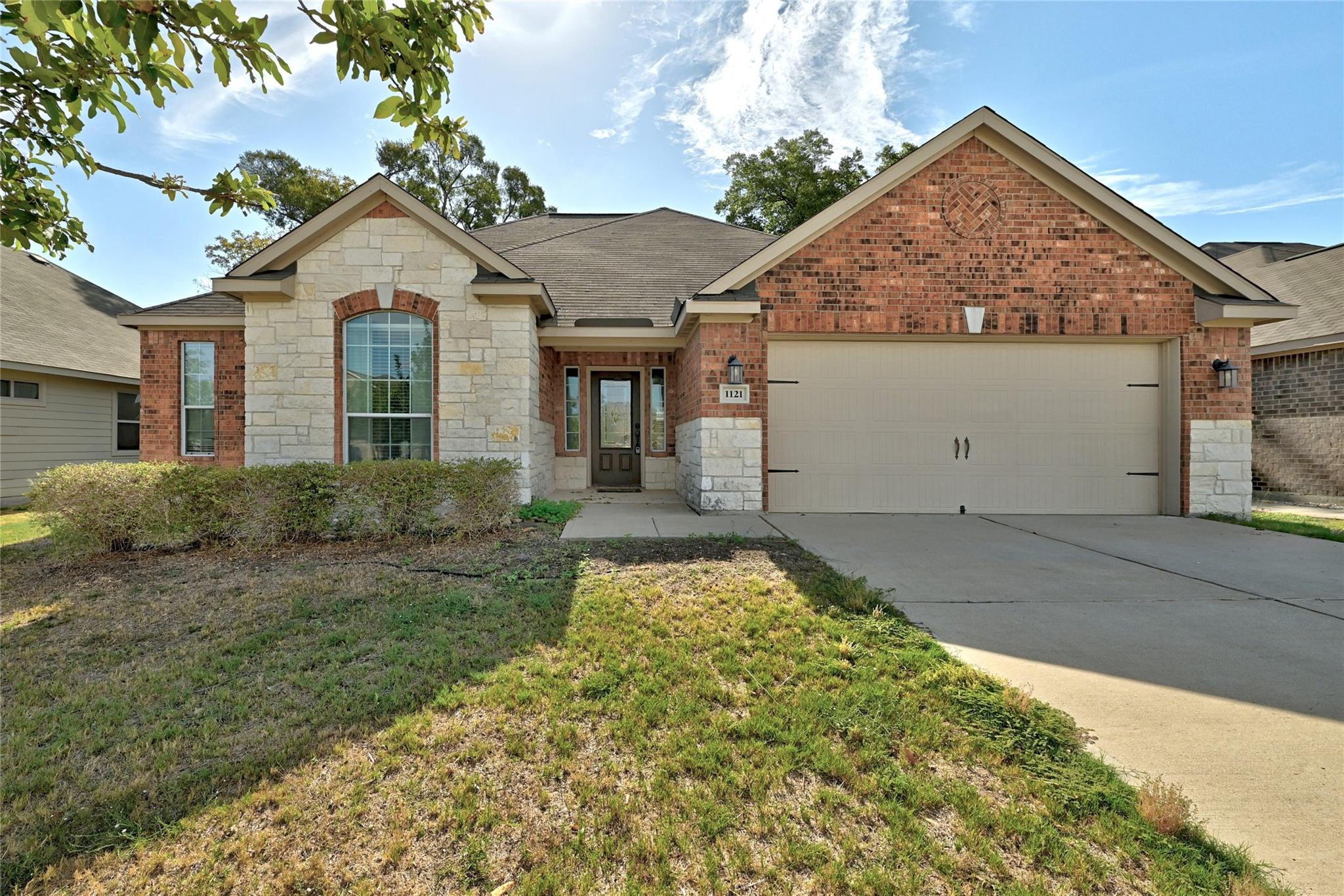 Timeless brick and stone exterior accents define 