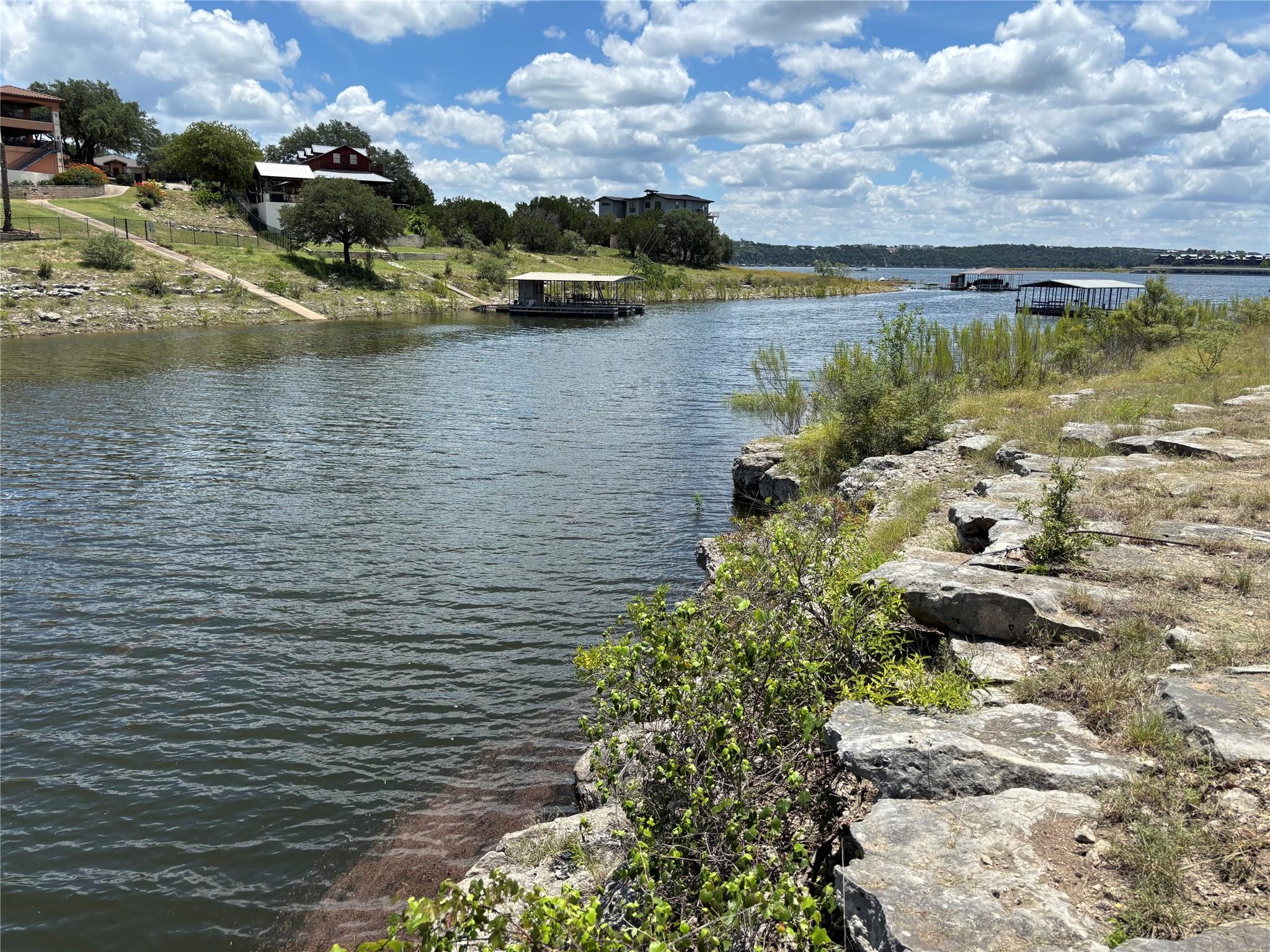 Natural rocky shoreline overlooks calm waters wit