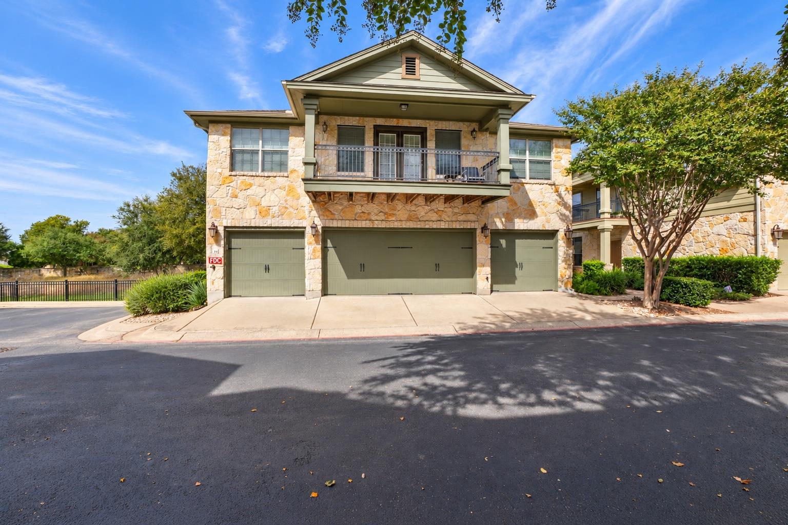 Natural stone masonry and multiple garage bays de