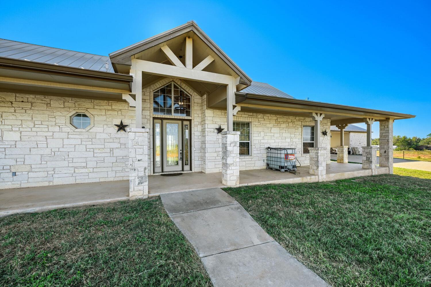 Stone masonry facades and a covered front porch c