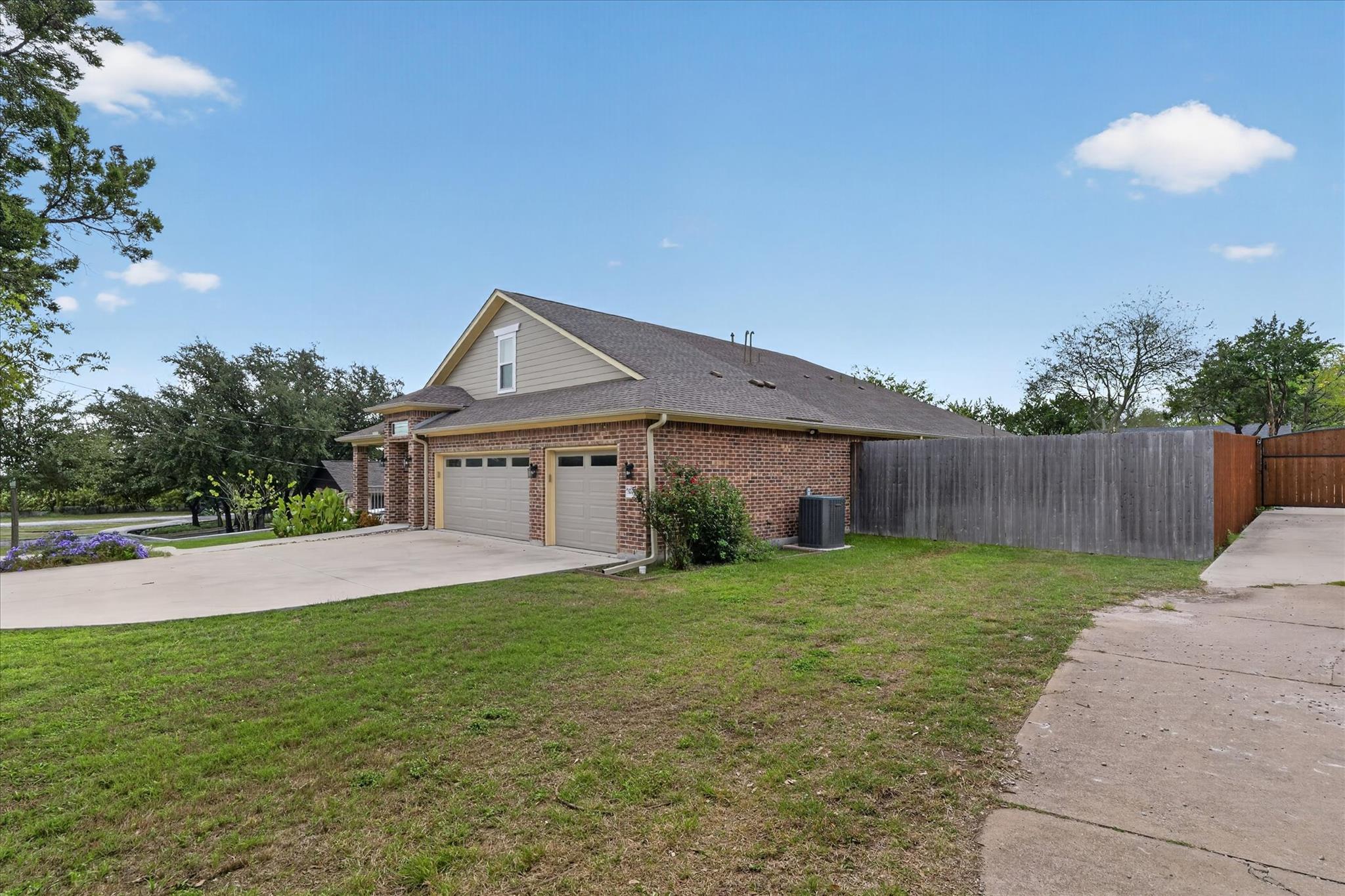 A spacious driveway leads to an attached multi-ca