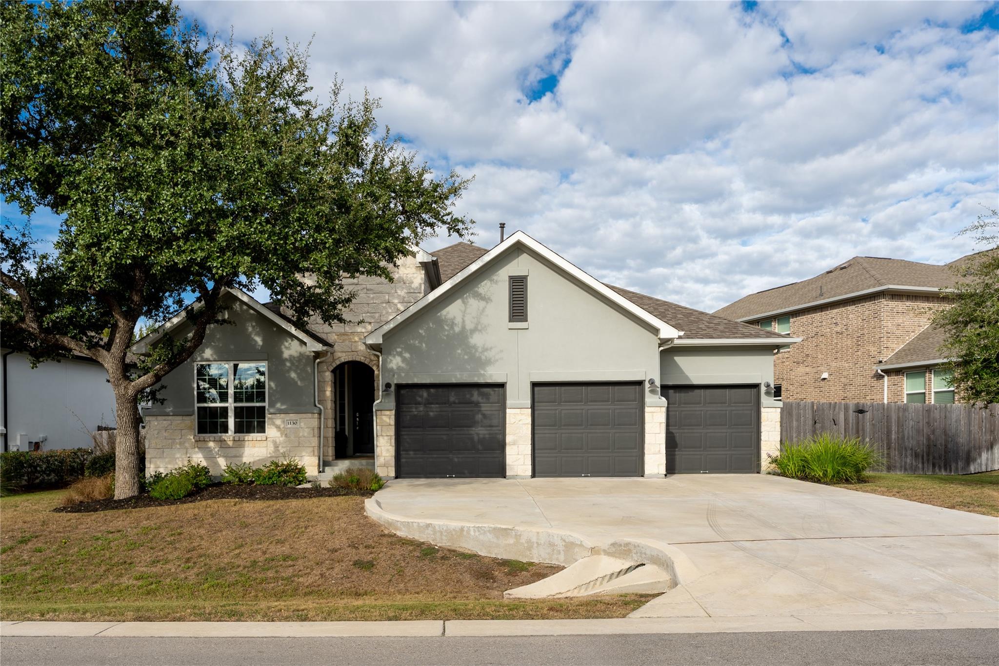 An inviting stone and stucco exterior features a 