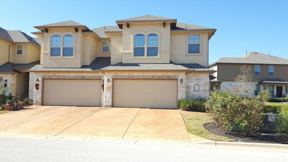 Multi-level stone and stucco exterior features a 
