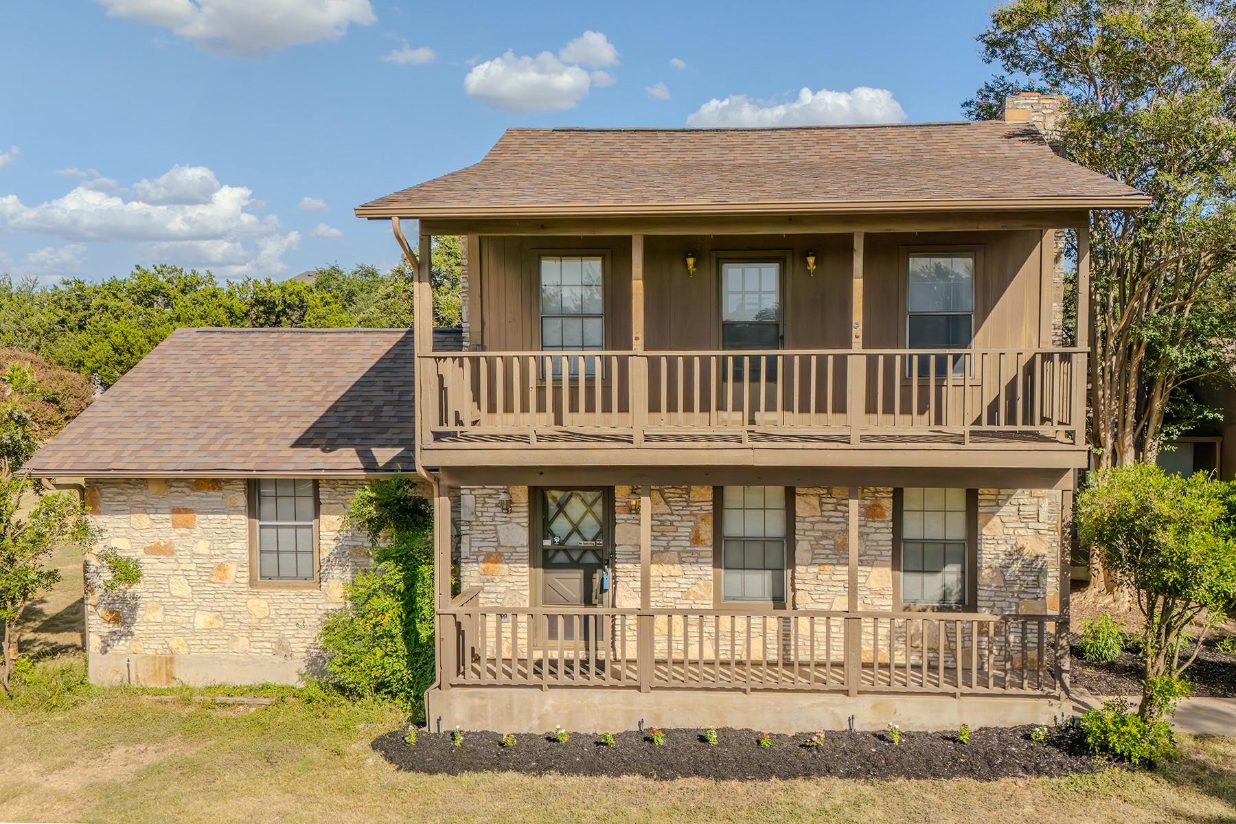 A charming stone and wood facade features a cover