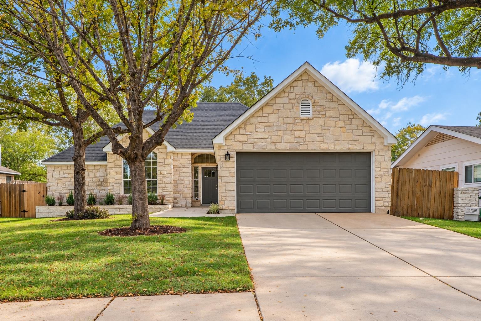 A classic stone exterior, gabled rooflines, and m
